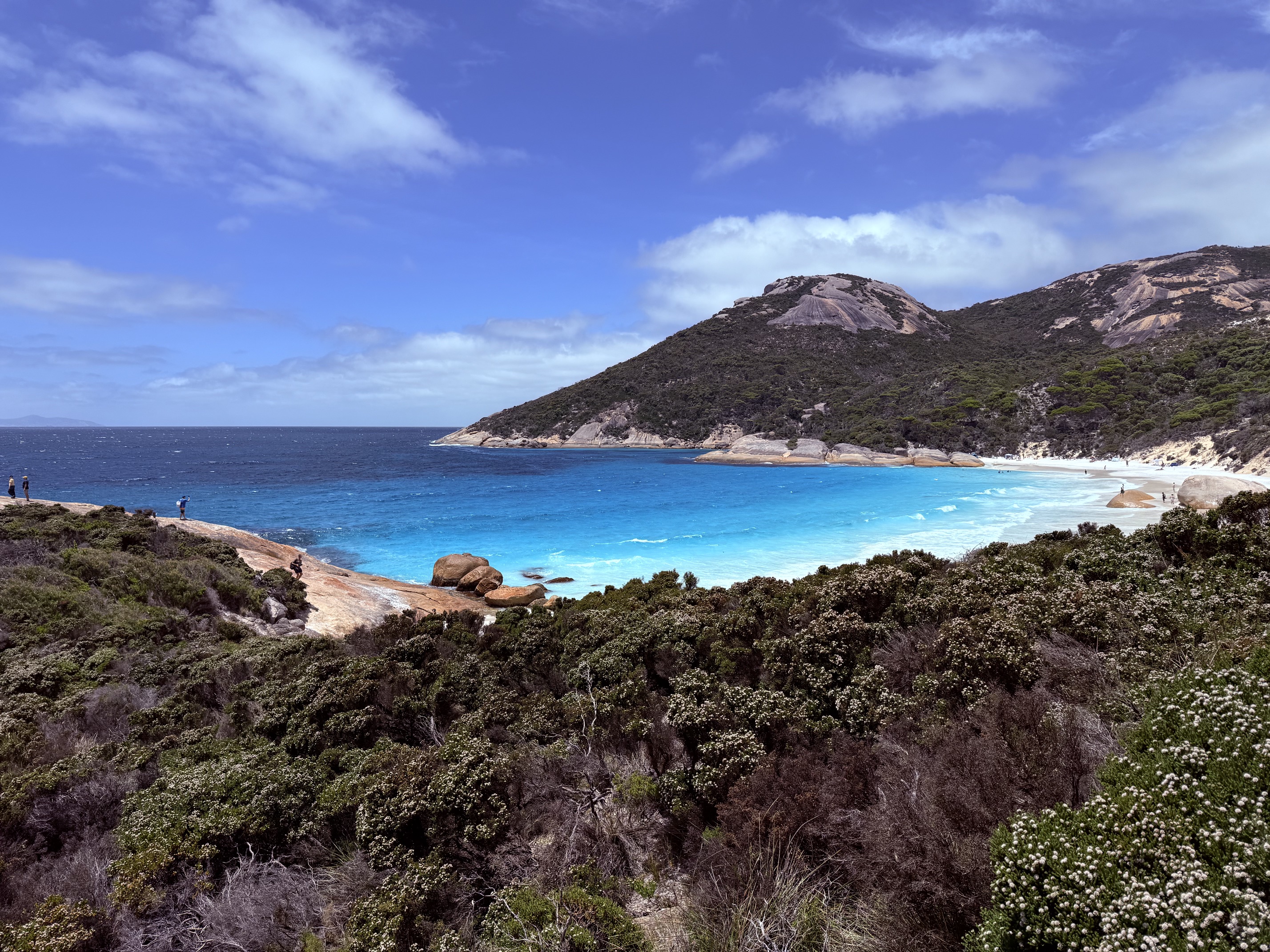 A picture of the crescent shaped beach, with pristine blue water